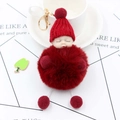Detailed view of burgundy fluffy fur ball keychain with a sleeping baby doll face - Burgundy