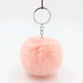 Detail of pink faux rabbit fur pom pom keychain with silver metal ring on leather strap - Pink