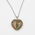 Close-up of heart-shaped Unakite stone pendant with natural green and red marble textures - Unakite