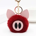 Détail macro du porte-clés cochon en peluche rouge avec oreilles en cuir PU et fermoir doré - Bordeaux