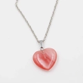 Pink heart-shaped natural stone necklace with silver metal chain on white background - Watermelon red