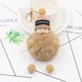 Portachiavi bebè che dorme in peluche con cappello a maglia e chiusura dorata - Cachi