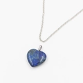 Close-up of heart-shaped lapis lazuli pendant with gold flecks on a silver chain - Lapis Lazuli