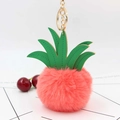 Detail of coral pink pineapple plush keychain with green leather leaves and gold hardware - Orange Red