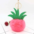 Close-up of pink fluffy pineapple plush keychain with green faux leather leaves - Watermelon red