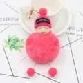 Pink sleeping baby plush keychain with gold carabiner on a decorative background - Watermelon red