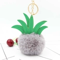 Detailed view of grey faux fur pineapple keychain with green PU leaves and gold metal clip - Light Gray