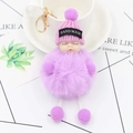 Detail of cute sleeping doll plush keychain with purple faux fur and handmade knit hat - Violet