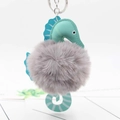 Detail of mint green faux leather seahorse plush keychain with soft grey fur ball - Light Gray