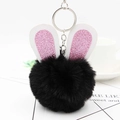 Detalle de un llavero de conejo negro con orejas de lentejuelas rosas y clip metálico - Negro