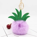 Close-up of a fluffy purple pineapple keychain with green PU leaves and golden ring - Light Purple