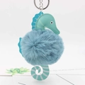 Detailed view of seahorse plush keychain with mint green leather and blue pom-pom ball - Lake Blue