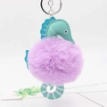 Detail showing plush seahorse keychain with mint green faux leather and purple faux fur ball - Light Purple