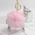 Detail of alpaca leather keychain with floral pattern and fluffy pink pompom accent - Light Pink