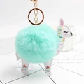 Detail of mint green plush ball keychain with floral white leather alpaca charm and gold clasp - Mint Green