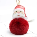 Detail of Santa plush keychain with faux leather head, red fluffy pompom and gold metal ring - Burgundy