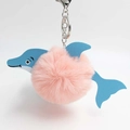 Detail of cute pink faux fur dolphin keychain with blue cross-textured leather and silver hook - Pink