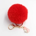 Close-up of red fluffy faux fur keychain with gold cat charm and pearl accents - Pom Pom Diameter 8cm / Red