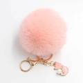 Close-up of pink fluffy pom pom keychain with gold kitten pendant and imitation pearl detail - Pom Pom Diameter 8cm / Pink