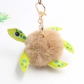 Detailed close-up of a plush turtle keychain with brown faux fur shell and green faux leather - Pom Pom Diameter 8cm / Khaki