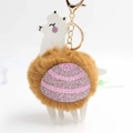 Detailed close-up of alpaca keychain with fluffy brown faux fur and pink sequins detail - Coffee