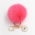 Detailed macro view of the fluffy pink pompom keychain with pearl bow pendant and gold clasp - Pom Pom Diameter 8cm / Watermelon red