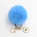 Detail showing bright blue fluffy faux fur ball keychain with bow and gold clasp - Pom Pom Diameter 8cm / Blue