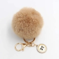 Detail of camel faux fur pompom keychain with golden clasp and pearl bow pendant - Pom Pom Diameter 8cm / Khaki