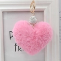 Detailed close-up of pink faux fur heart keychain with sparkling rhinestone bead and gold ring - Pink