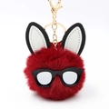 Detail of red plush rabbit pompom keychain with golden metal clasp and sunglasses - Burgundy