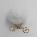 Detail of white fluffy pompom keychain with gold hardware and pearl bow charm - Pom Pom Diameter 8cm / White