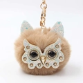 Fluffy owl keychain with gold glitter mask and brown faux fur on white background - Khaki