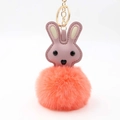 Detailed view of pink leather rabbit head with orange faux fur pompom and gold keychain - Pom Pom Diameter 8cm / Orange Red