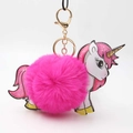 Close-up of bright pink faux fur pompom unicorn keychain with golden metal clasp - Rose Red
