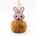 Close-up of pink leather bunny keychain with dark brown fluffy pom-pom and gold metal ring - Pom Pom Diameter 8cm / Coffee