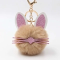 Detail of cute rabbit plush keychain with soft brown faux fur and pink glitter ears - Khaki