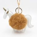 Unicorn keychain with brown plush pompom and white faux leather accents on white background - Coffee