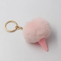 Detail of pink faux fur pompom ice cream keychain with golden metal ring and textured cone - Light Pink
