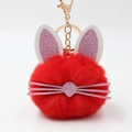 Detail of red plush rabbit keychain with glittery pink ears and golden metal clasp - Red