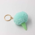 Detailed macro view of mint green plush pompom ice cream keychain with golden ring - Mint Green
