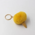 Close-up of yellow faux fur pompom ice cream keychain with a textured resin cone - Antique Yellow
