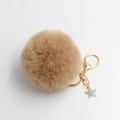 Detail of soft beige faux fur pompom keychain with golden clasp and blue starfish charm - Khaki