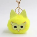 Détail du porte-clés hibou pompon jaune avec oreilles pailletées et fermoir doré chic - Jaune