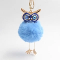 Detail of light blue fluffy owl keychain with gold hardware and sparkling gemstone eyes - Light Blue