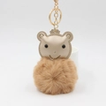 Detailed view of the plush bear keychain featuring a brown fur ball and golden metal ring - Khaki