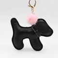 Cartoon black leather puppy keychain with a pink fluffy pompom and golden metal clasp - Black With Hairball