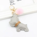 Detail of grey leather bulldog keychain with pink faux fur pompom and golden clasp - Gray With Pompom