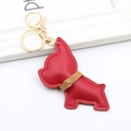 Detail view of a red leather French Bulldog keychain with golden hardware and stitching - Burgundy