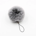 Macro detail of fluffy grey and white faux fur pompom keychain with a black lanyard - Frost Black