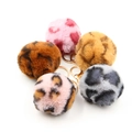 Detail view of five plush leopard print keychains with golden metal ring and lobster clasp - Random Style